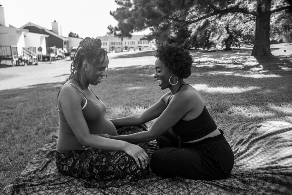 Duola consulting a pregnant client while in a park